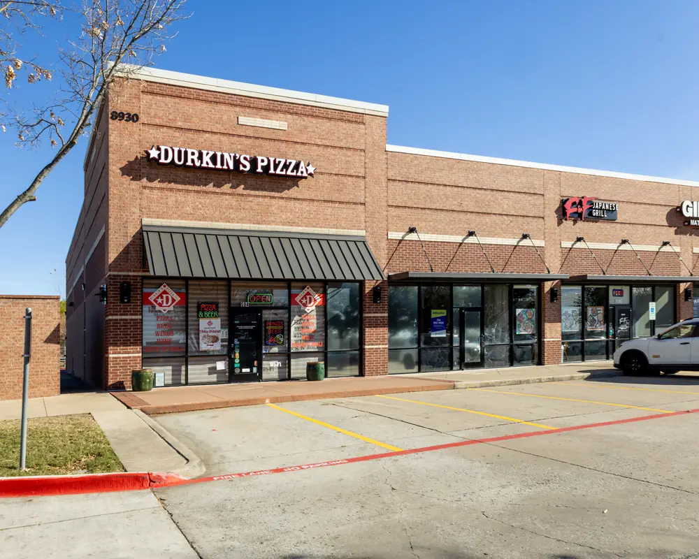 Durkin’s Pizza storefront at 8930 State Hwy 121 Ste 594 in West McKinney, TX: look for the red-brick building with the dark awning
