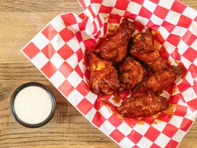 Baked chicken wings tossed in sauce with ranch at Durkin’s Pizza